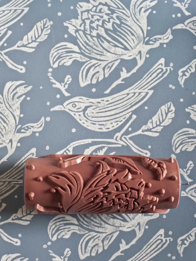 Flock Patterned Paint Roller, painting wall with blue and white pattern. 