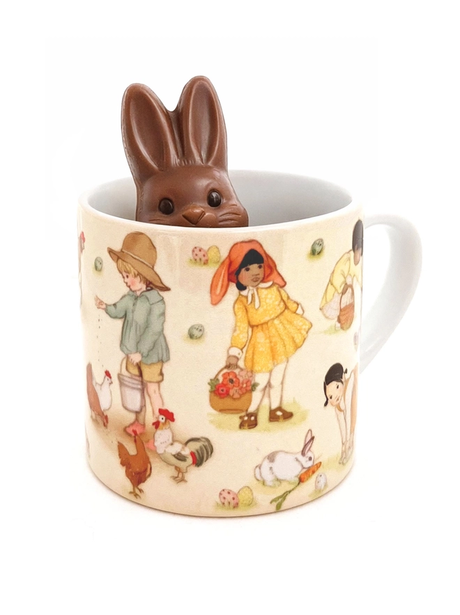 a chocolate bunny peeking out of an easter mug for a child