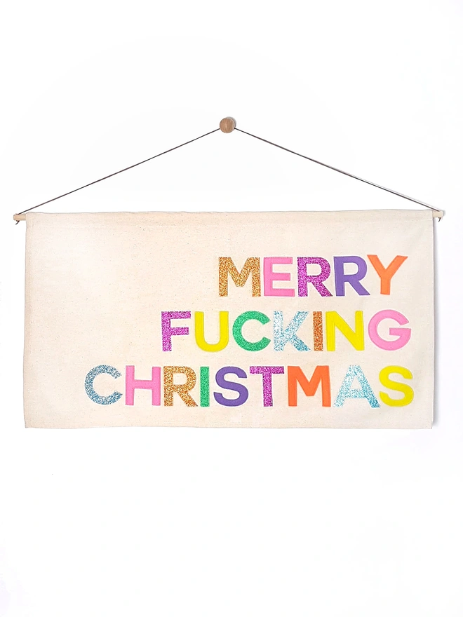 Handmade “Merry F***ing Christmas” banner in felt & cotton. A cheeky festive wall hanging that makes the perfect funny Christmas decoration.