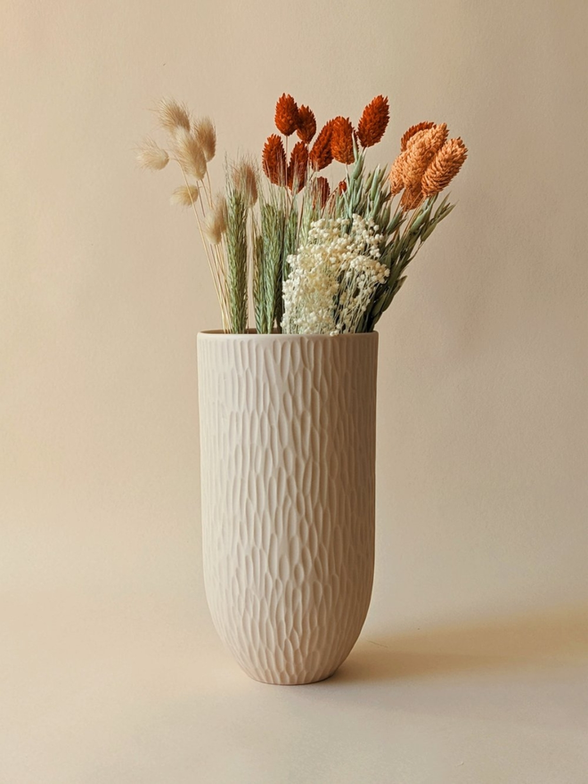 handmade textured oat coloured vase with dried flowers