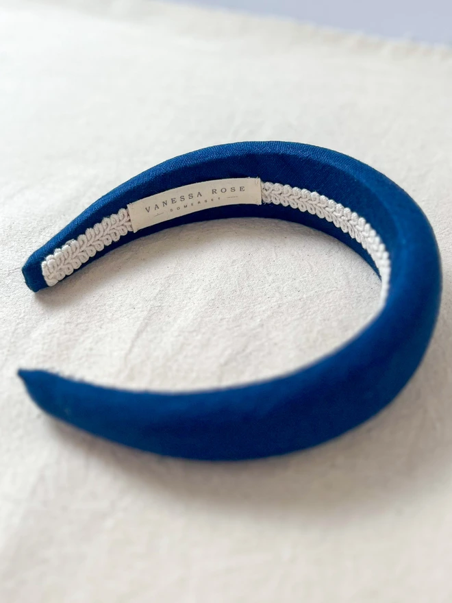 navy linen padded headband on side to show ribbon