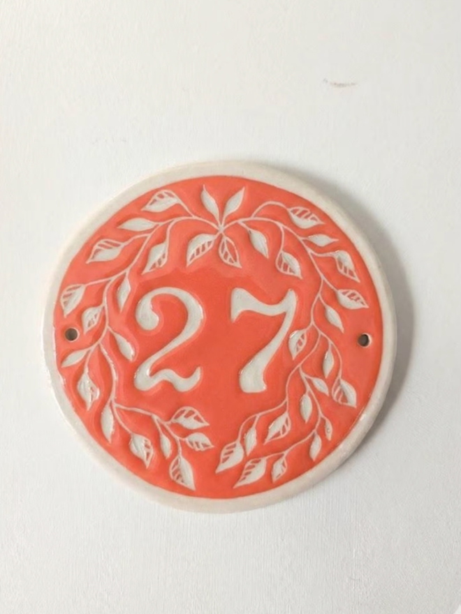 Custom Round Ceramic House Number with Leaves. A house number in paprika.