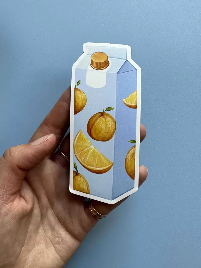 A blue carton of orange juice magnet