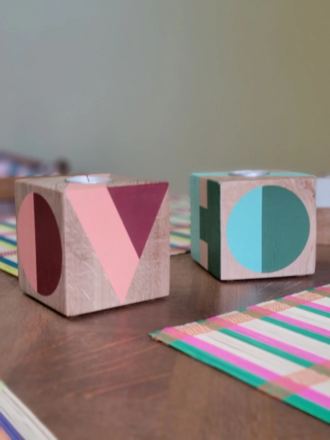 Painted wood cube tealight holders on table