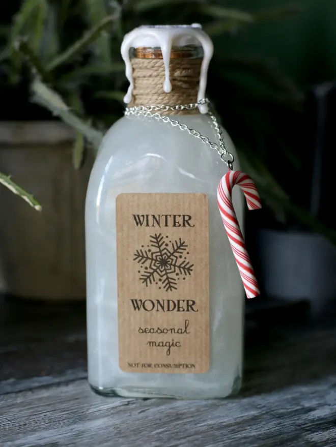 winter wonder christmas magic potion with candy cane charm and a wax seal