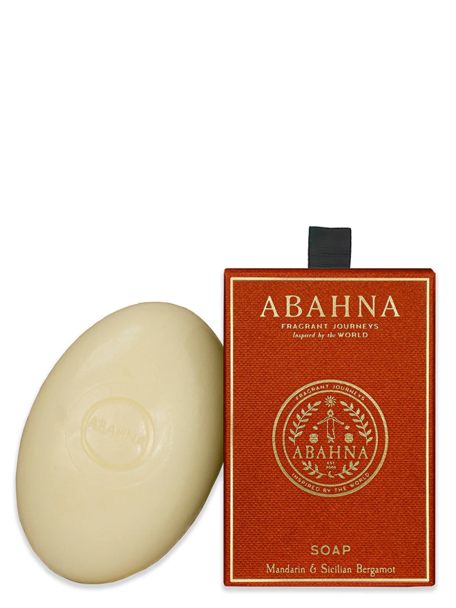 mandarin and sicilian bergamot soap bar. a bar of natural soap leaning on an orange gift box.