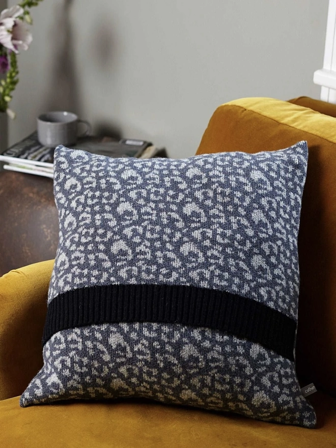 Lambswool Patterned Cushion, a cushion sitting on a yellow chair in a living room. 