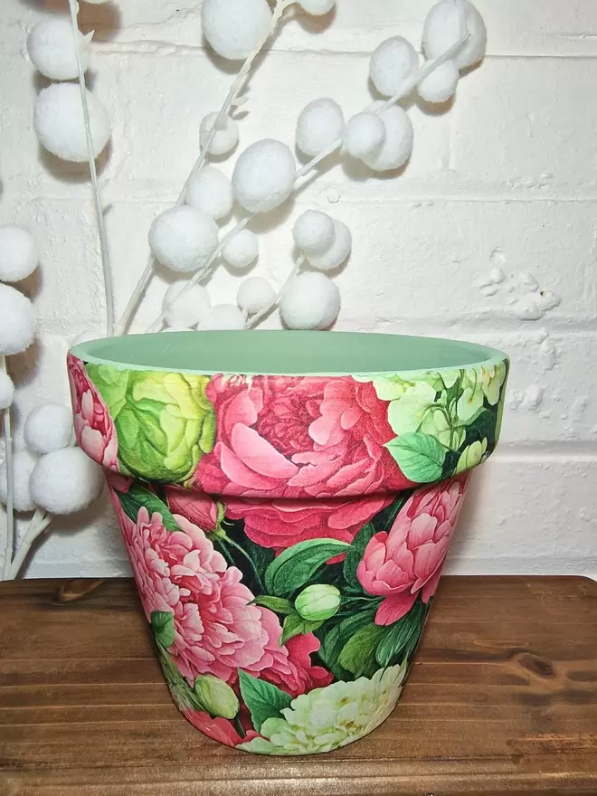 Pink Peony Plant Pot on a wooden bench