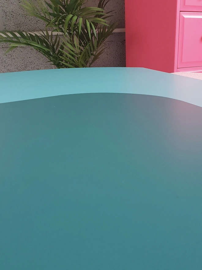 Close up view of the top of teal painted coffee table by Orange Otter