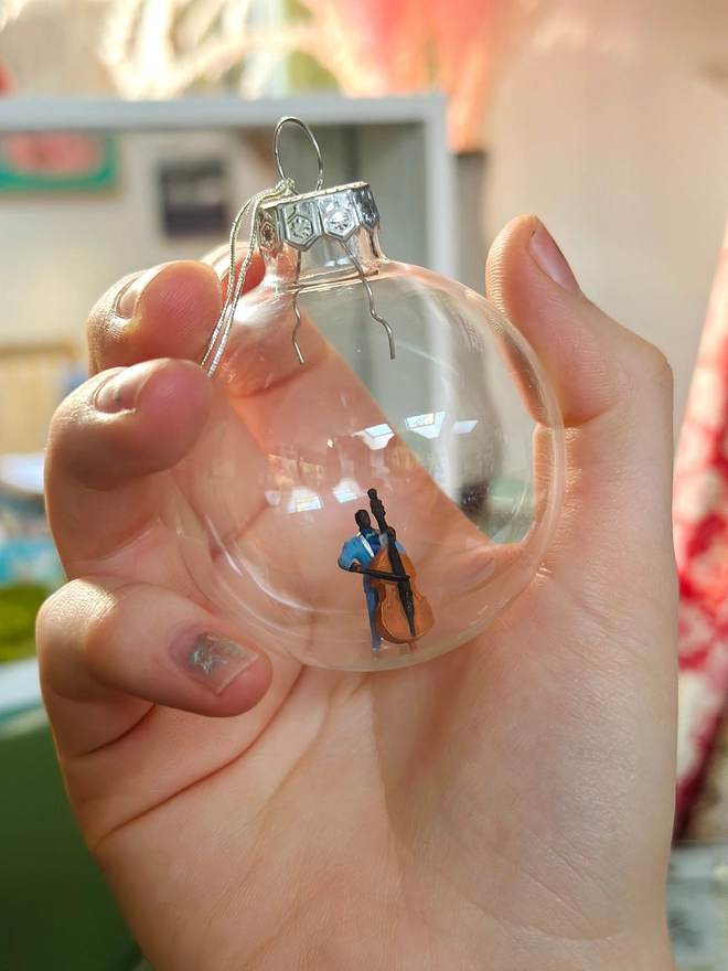 Hand holding a bauble to show scale