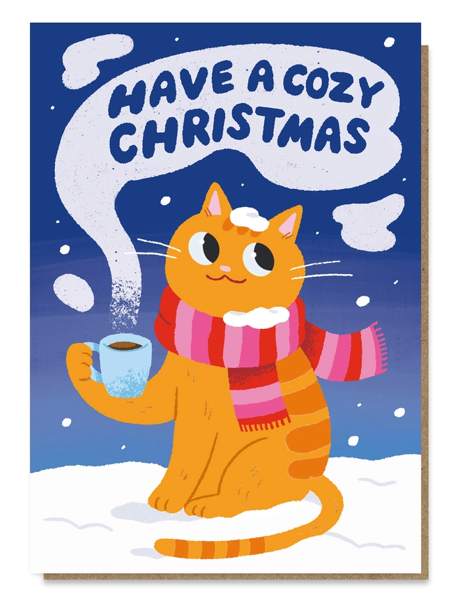 Ginger tabby cat wearing a pink striped scarf, holding a hot drink with "Have a cozy Christmas" written in the steam.