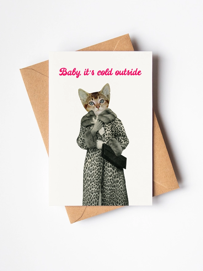 A funny Christmas card featuring a cat wearing a leopard print coat.