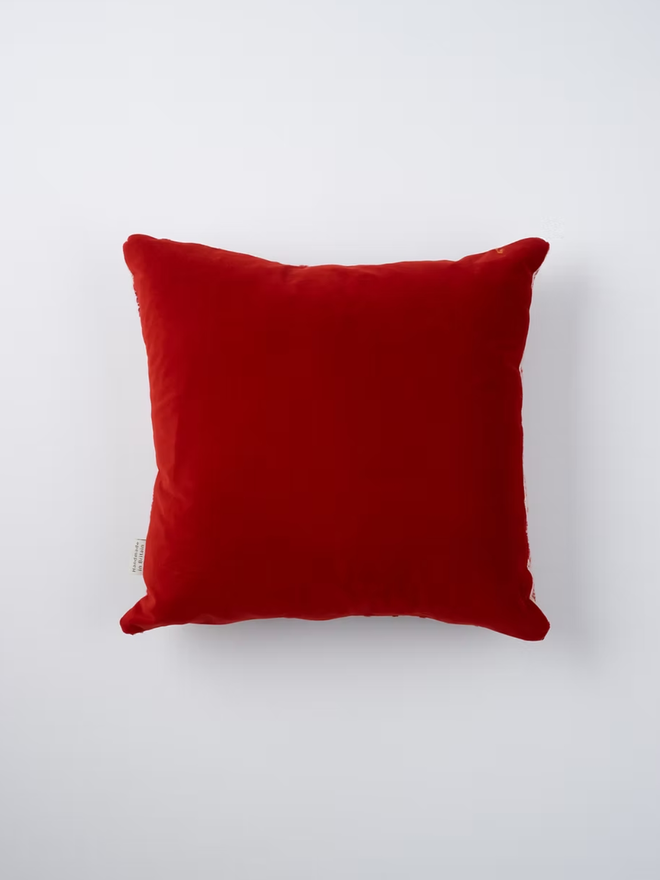 lobster square cushion. the velvet back of a square cushion, photographed on a plain background.