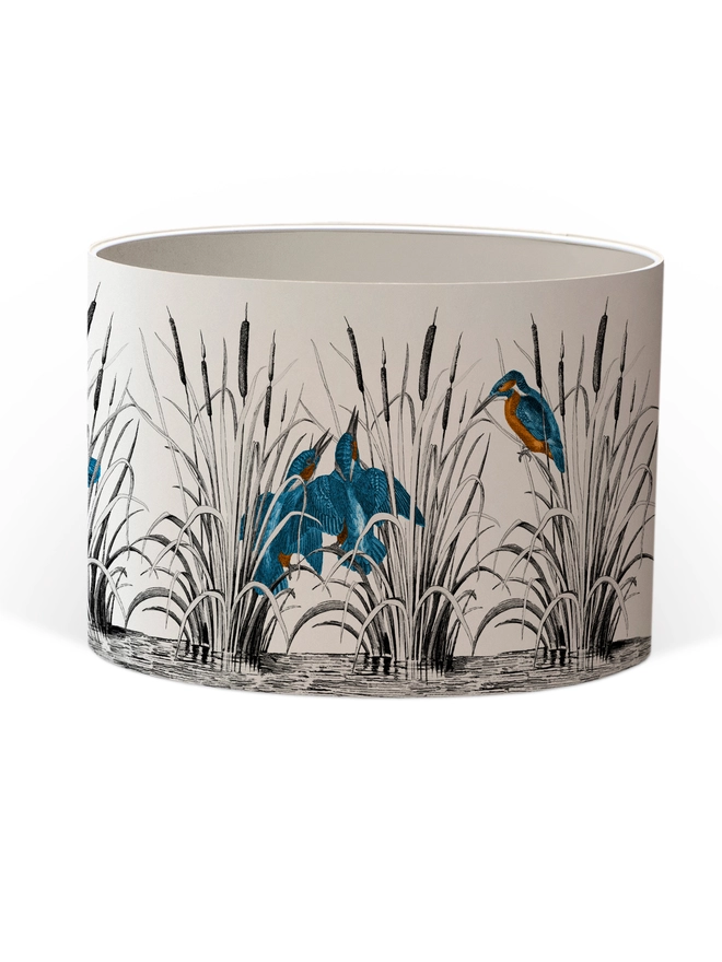 Handmade lampshade featuring vibrant kingfishers among bulrushes in a whimsical countryside-inspired design, combining nature, colour, and artisan style.