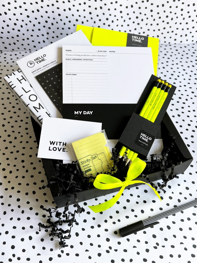 Stationery selection gift box filled with a year planer, productivity pad, pencils, diary sticker pack and pen. Black with a pop of neon yellow