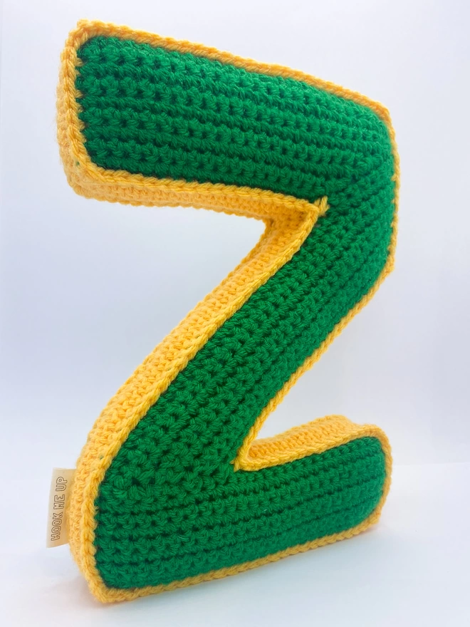 Crochet cushion shaped like a Z in Grass Green and Pale Orange