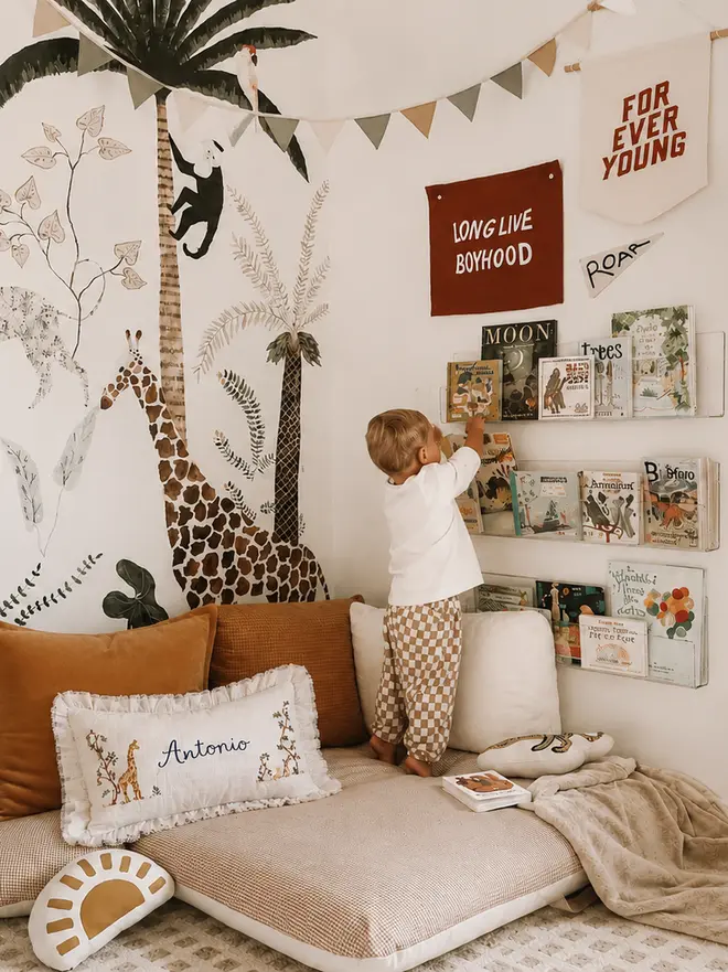 Little boy in reading corner - safari themed bedroom- personalised name safari linen cushion blossom and bramble e