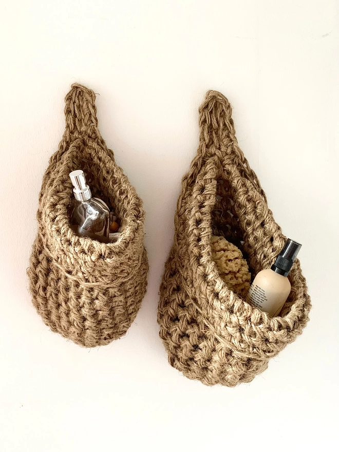 small and large brown jute hanging storage baskets, handmade sustainable crochet decor, rustic natural organic homeware accessories , brown strong jute storage solution, kitchen bathroom bedroom hanging storage bag