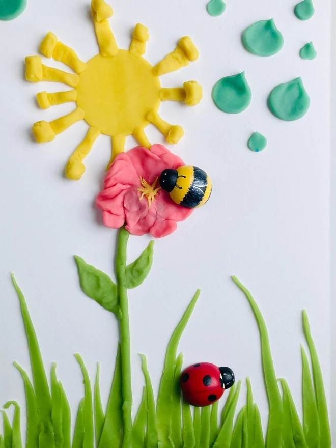 fairy sensory play dough sensory set. a a drawing of flowers with dough plants on top.