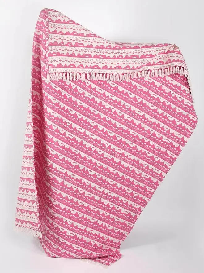 Pink Belle Mare Woven Throw, a pink throw standing against a white backdrop. 