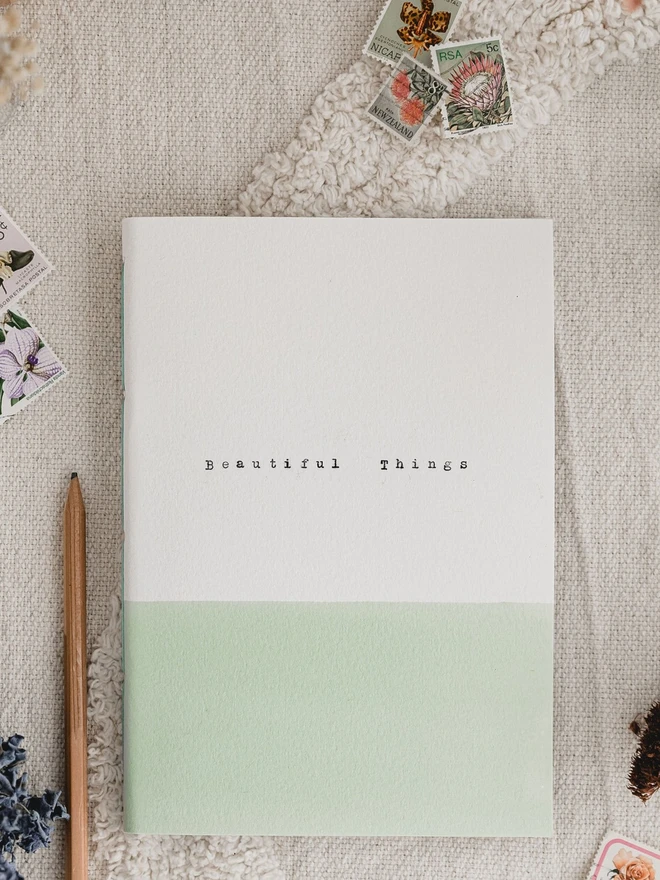 soft green and white gratitude journal with the words 'beautiful things' typed on the cover