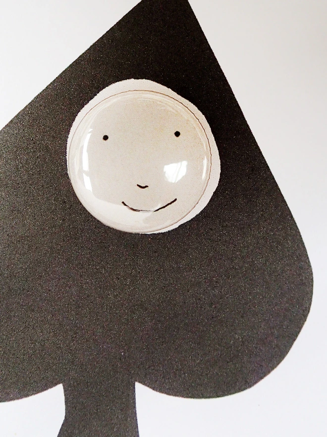ace of spades greeting card with happy face pin badge