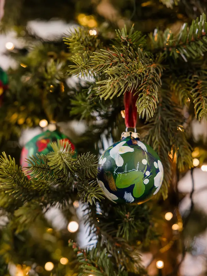 a set of six hand vibrant painted floral ceramic baubles all painted with an array of winter florals each finished with a luxurious velvet ribbon 