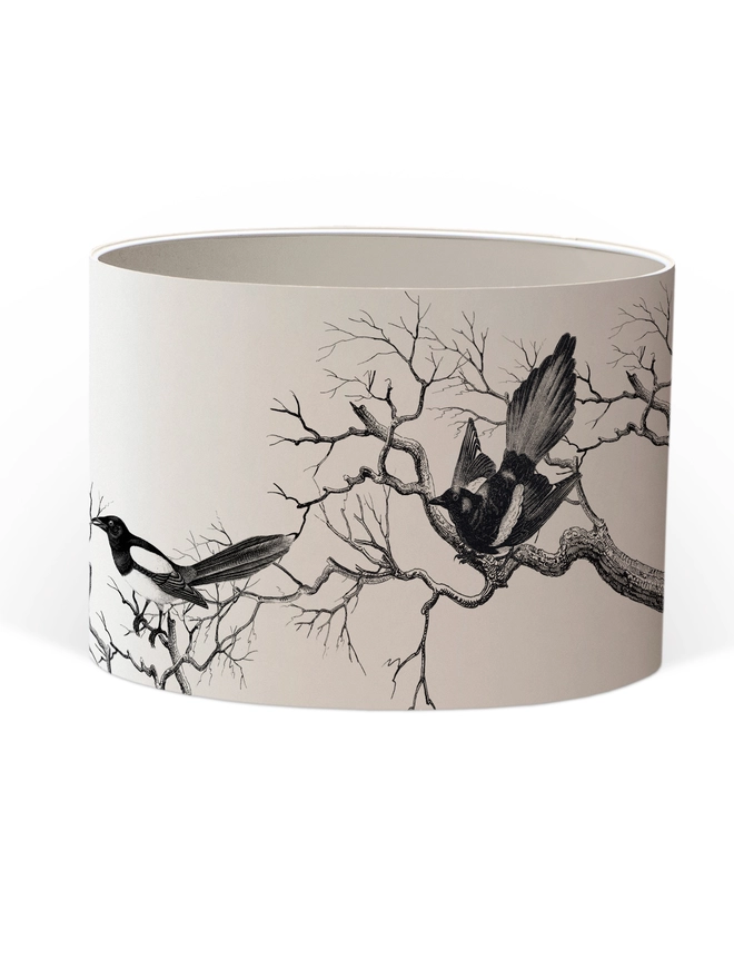 Handmade lampshade featuring cheeky magpies with gleaming gold details, inspired by traditional folklore and whimsical home decor.