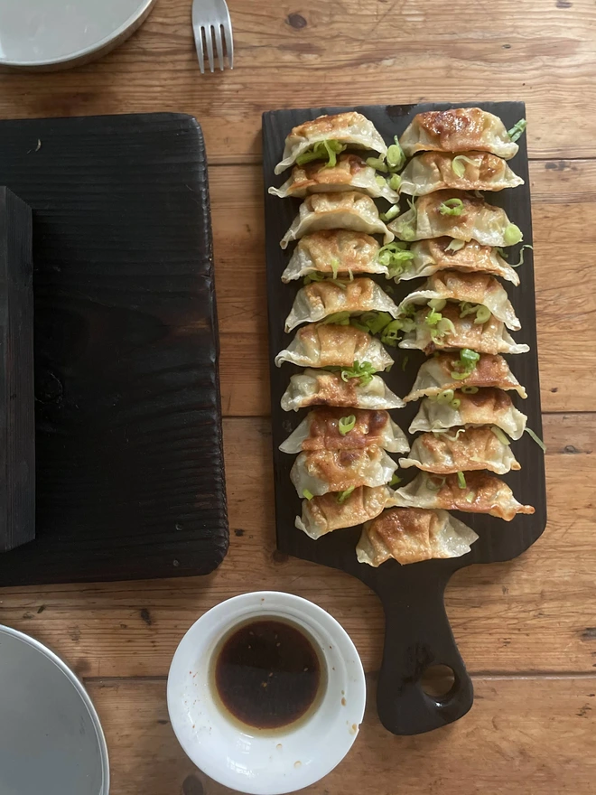 Small round handle yakisugi board with dumplings