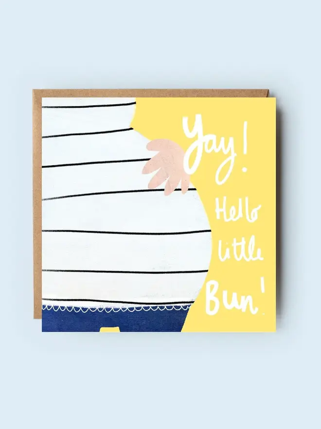 'hello little bun' illustrated new baby card. card photographed against plain blue backdrop.