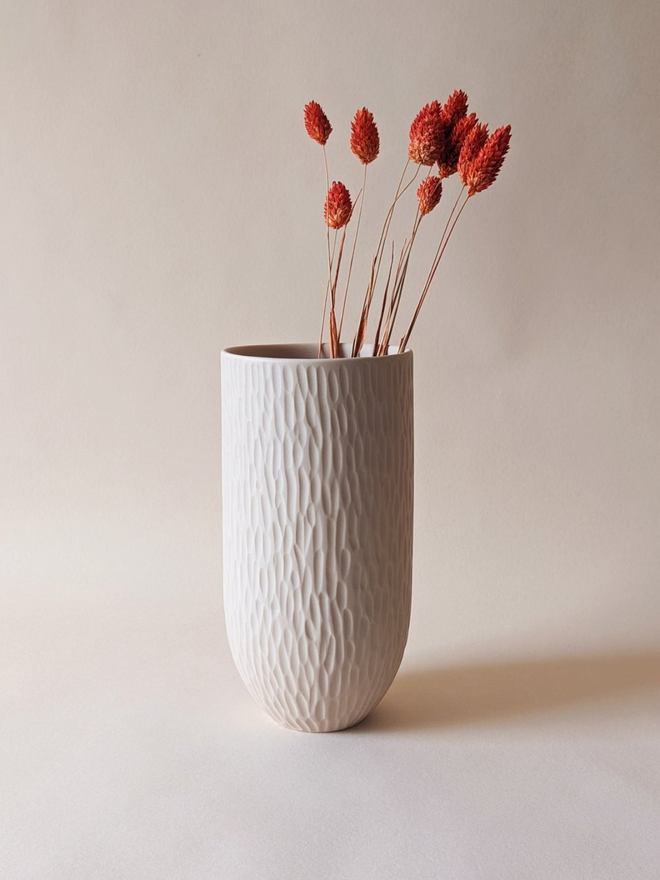 handmade textured oat coloured vase with dried flowers