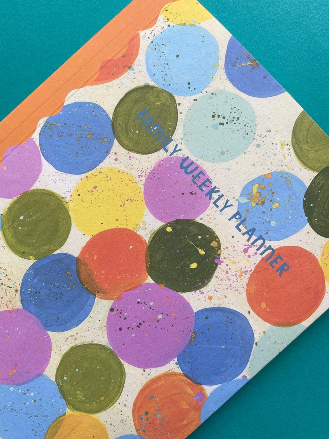 Close up view of Raspberry Blossom Family Weekly Planner painterly colourful spots design