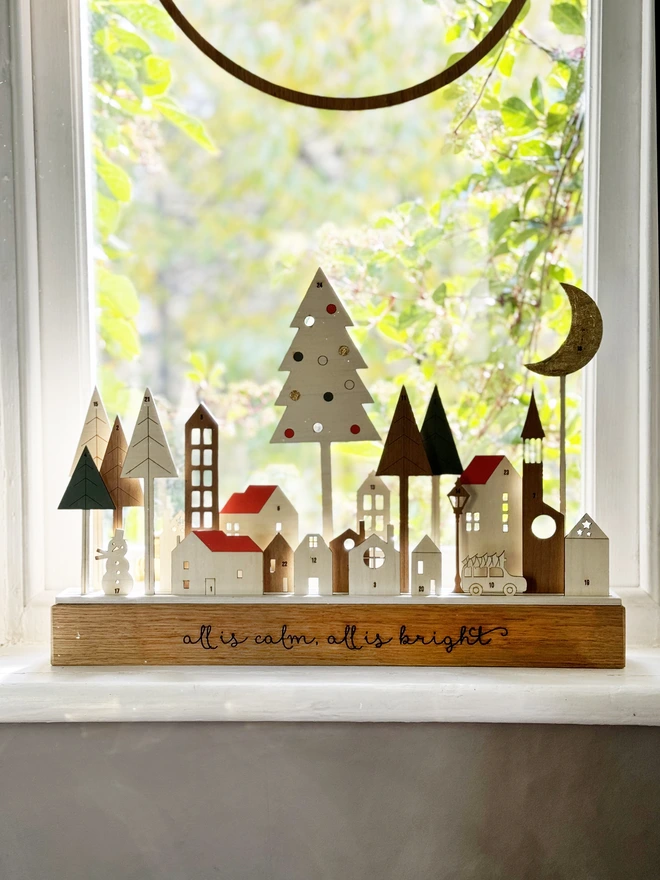 advent village scene on windowsill