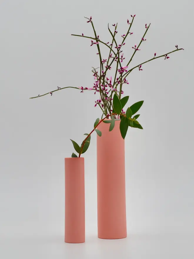 2 pink stem vases with flowers