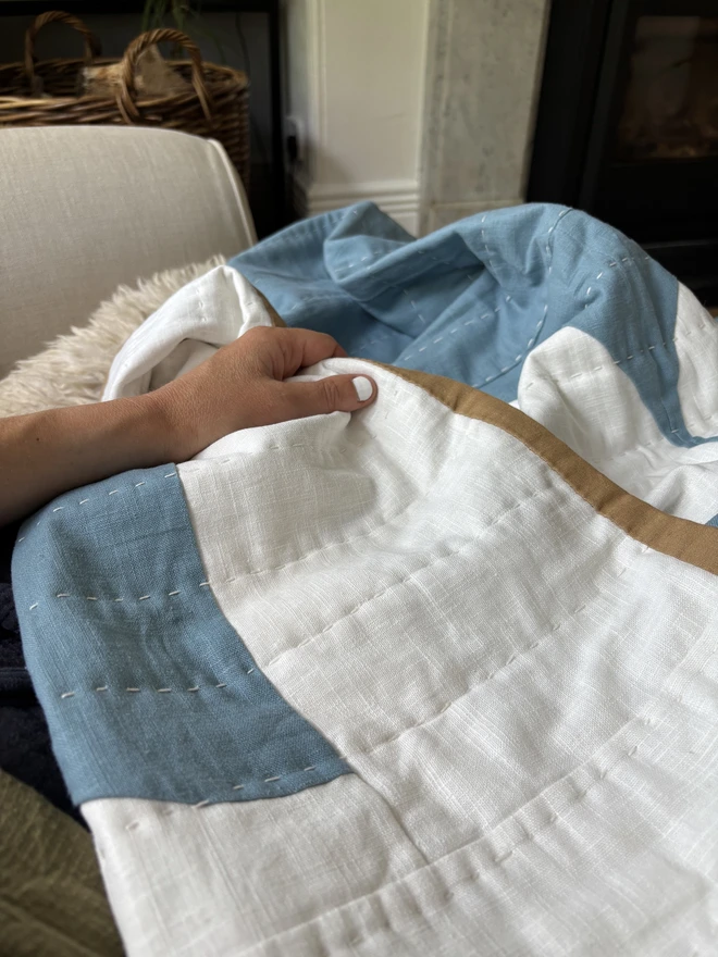 Wax & Wane Reversible Linen Throw Quilt. A blue & white hand quilted linen throwquilt.