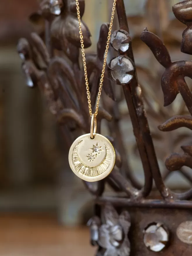 Luna Moon Diamond necklace seen on metal.