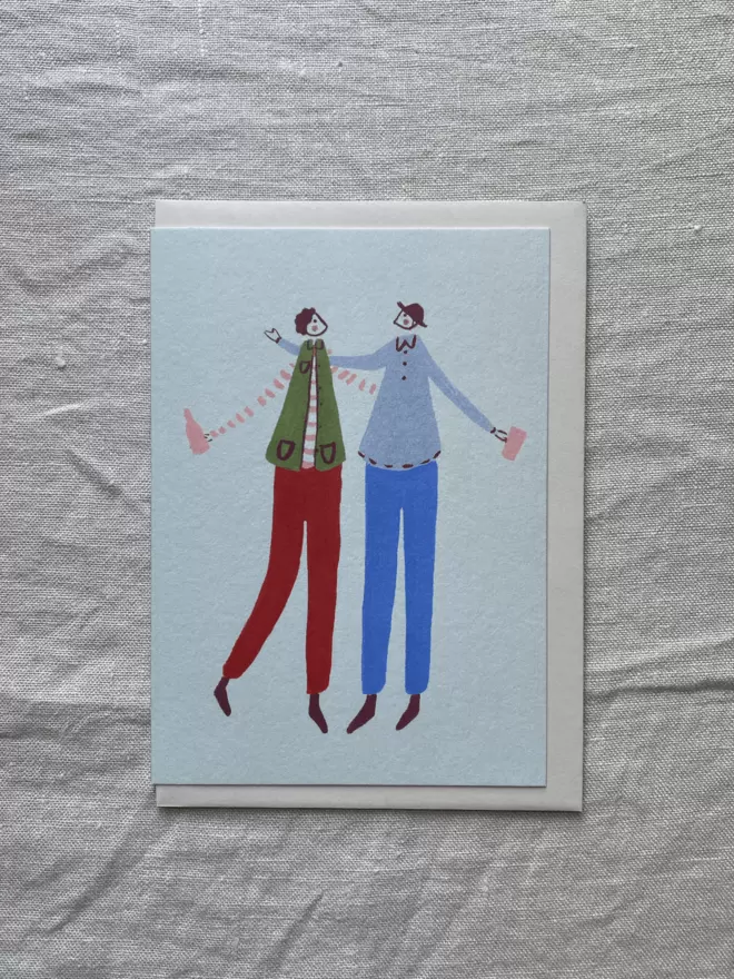 greetings card with 2 male best friends hugging and celebrating