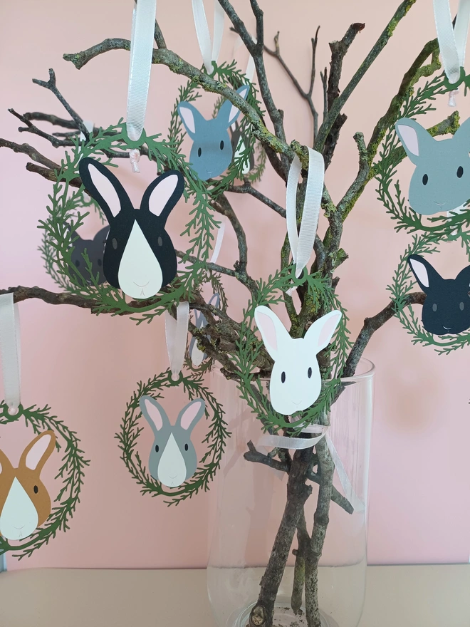 Entire range of easter tree bunny decorations displayed on easter tree in front of pink wall