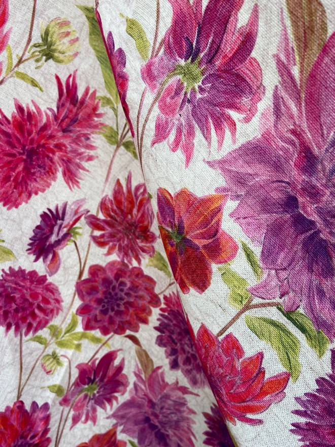 Dahlia Tablecloth. A tablecloth printed with vibrant pink flowers.