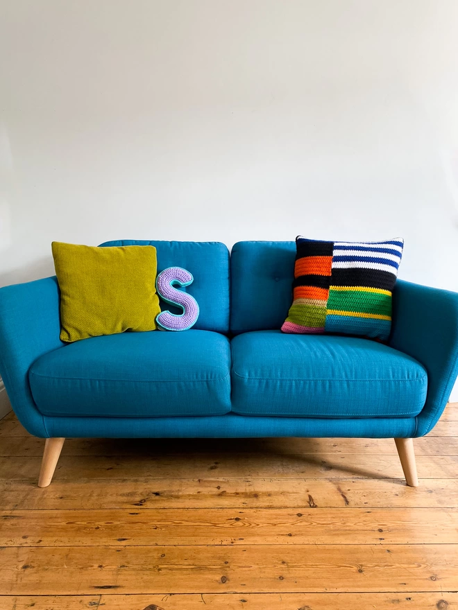 Crochet Cushion shaped like an S on a sofa