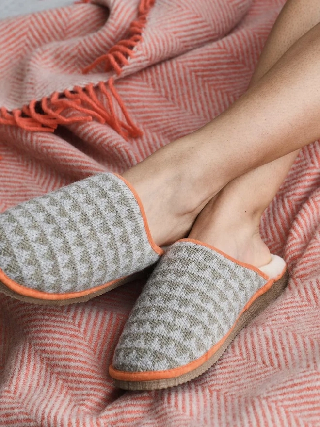 Lambswool & Sheepskin Slippers, a person wearing a pair of colourful lambswool and sheepskin slippers. 