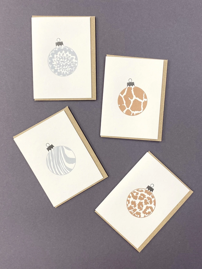 Four metallic animal print letterpress Christmas baubles 