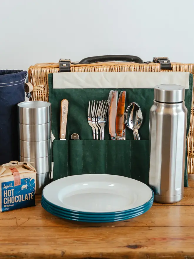 willow complete picnic hamper. a willow wood picnic basket filled with picnic cutlery, plates and cups.