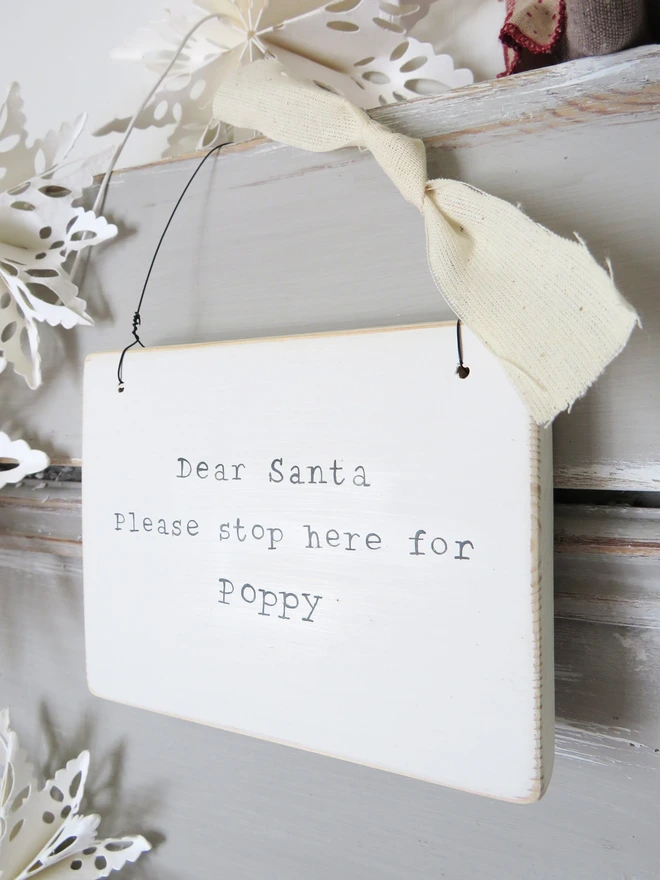 Chalky white painted wooden hanging sign with hand painted personalised Dear Santa message
