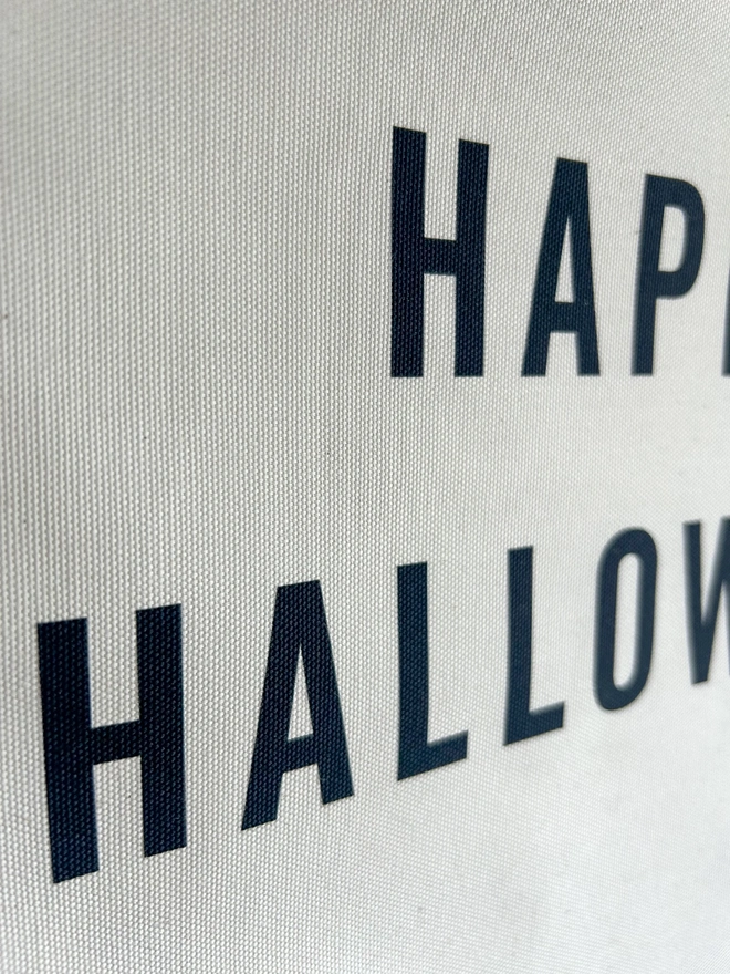 Happy Halloween printed in black on natural cotton fabric