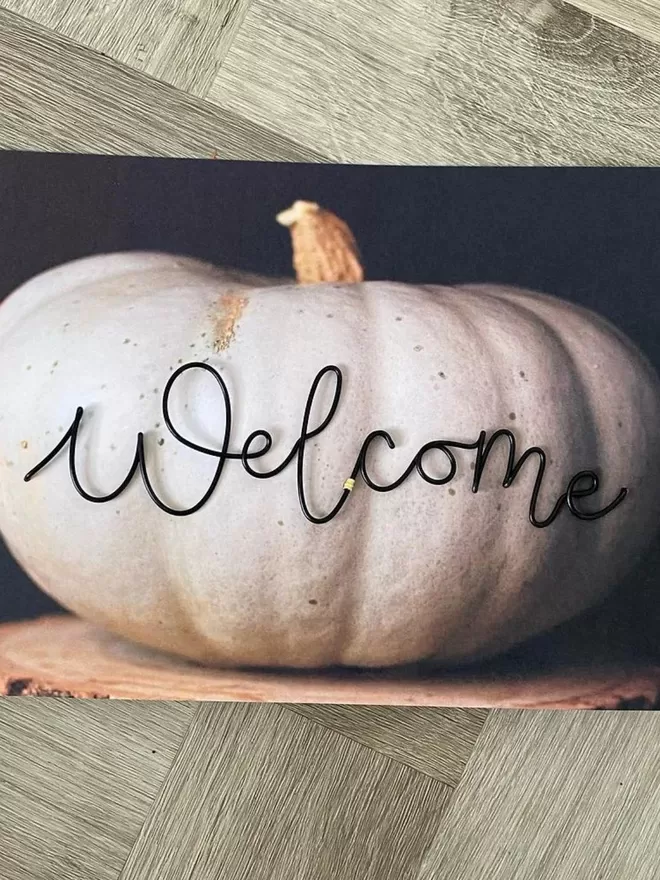 Welcome black sign for halloween by wired moments seen in the packaging.