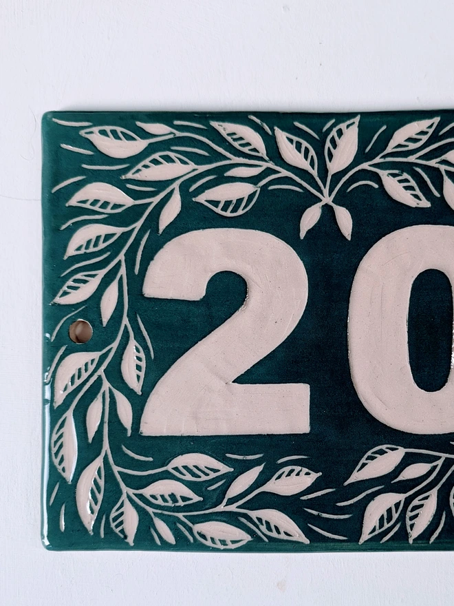 Personalised Ceramics House Number Leaf Tile. A tile in Mallard Green.