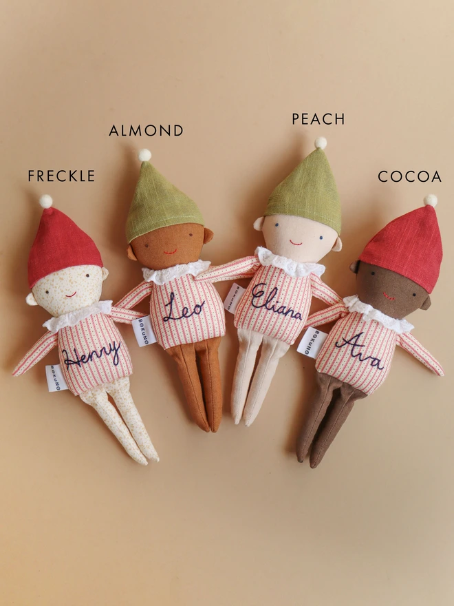 handmade elf dolls in stripe top and red or green hat with a name embroidered, in four different skin tones. 
