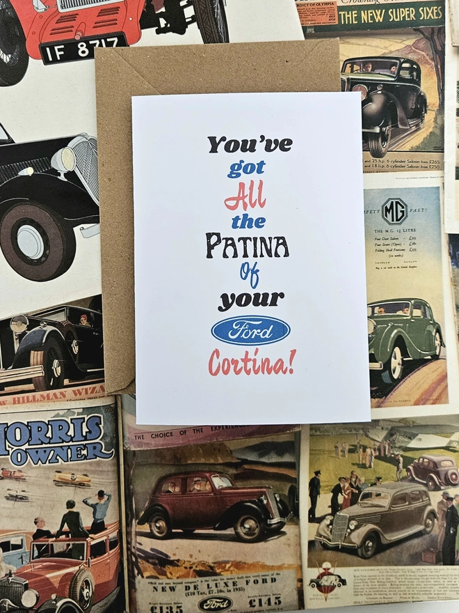 A birthday card that says minor imperfections just like your Morris written in vintage style font on a white card. The colours of the words are green, blue, red and black