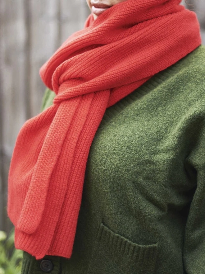 Lambswool Ribbed Scarf, a woman wearing a colourful ribbed scarf outdoors. 